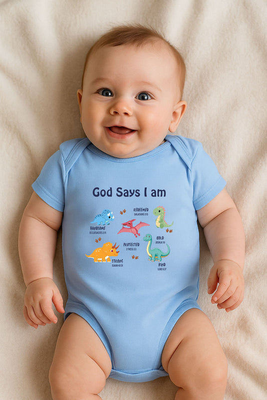 Blue baby bodysuit with dinosaur illustrations and Bible verses, titled “God Says I Am.”