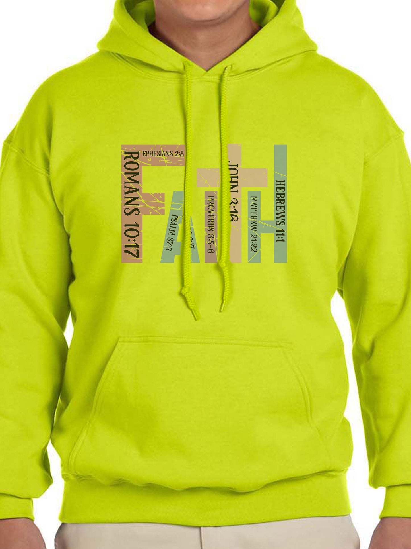 Man wearing a Safety Green hoodie with the word “FAITH” printed in block letters across the chest. Each letter is filled with a Bible verse reference, including Romans 10:17, Ephesians 2:8, Psalm 37:5, Proverbs 3:5–6, John 3:16, Matthew 21:22, and Hebrews 11:1. The design combines bold typography and scripture for a powerful, faith-centered statement.