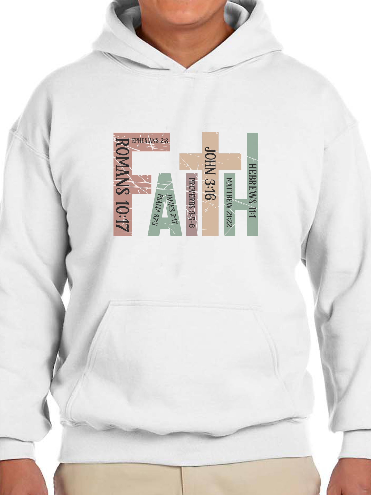 Man wearing a White hoodie with the word “FAITH” printed in block letters across the chest. Each letter is filled with a Bible verse reference, including Romans 10:17, Ephesians 2:8, Psalm 37:5, Proverbs 3:5–6, John 3:16, Matthew 21:22, and Hebrews 11:1. The design combines bold typography and scripture for a powerful, faith-centered statement.