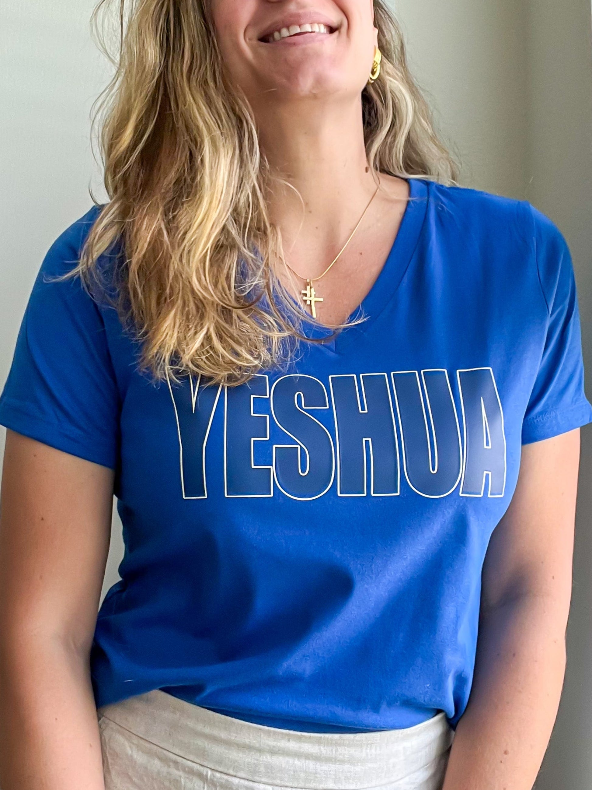Blue V-neck T-shirt with bold Yeshua HTV design worn by smiling woman