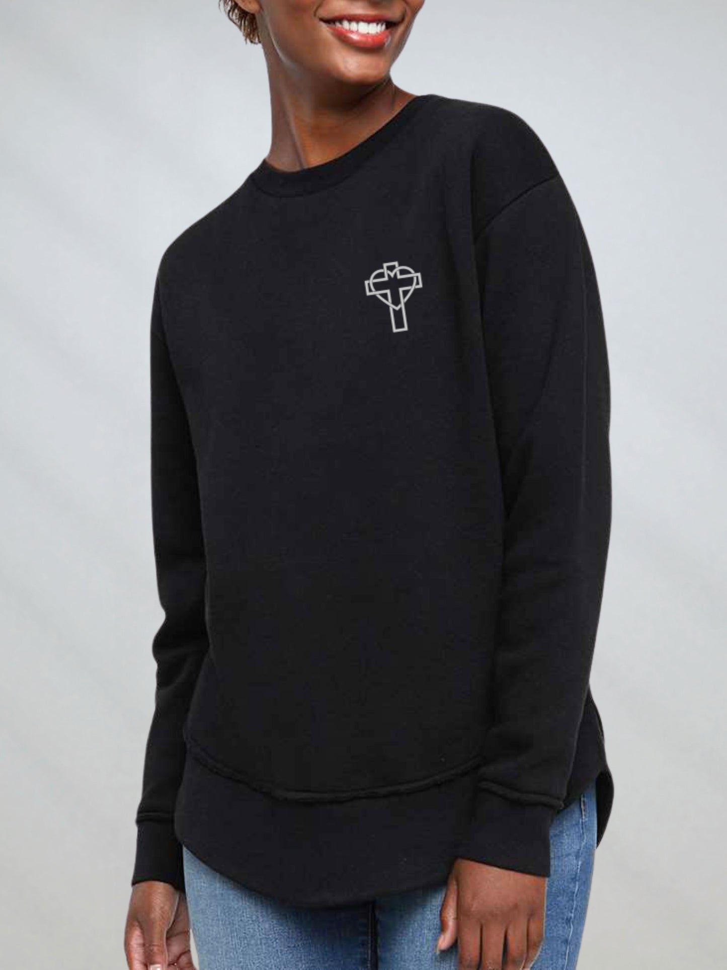 Front of the oversized black crewneck sweatshirt with cross outline on chest