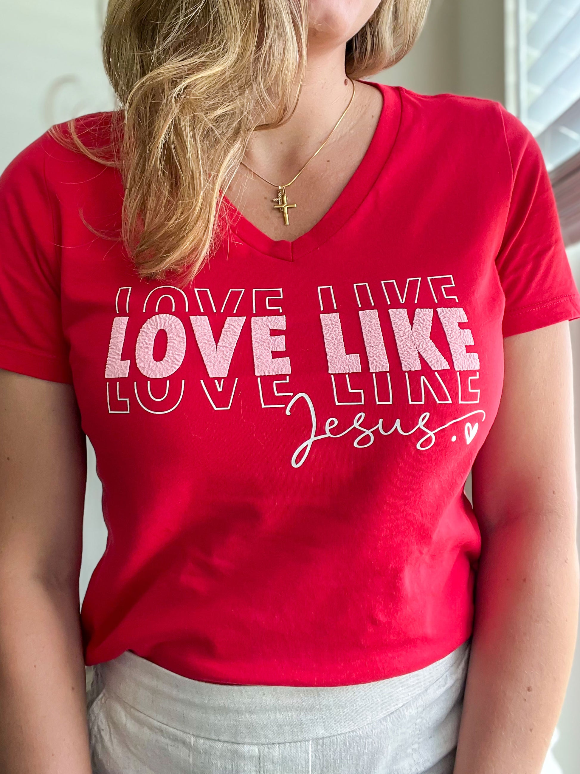 Love Like Jesus” puff print design on red v-neck t-shirt.