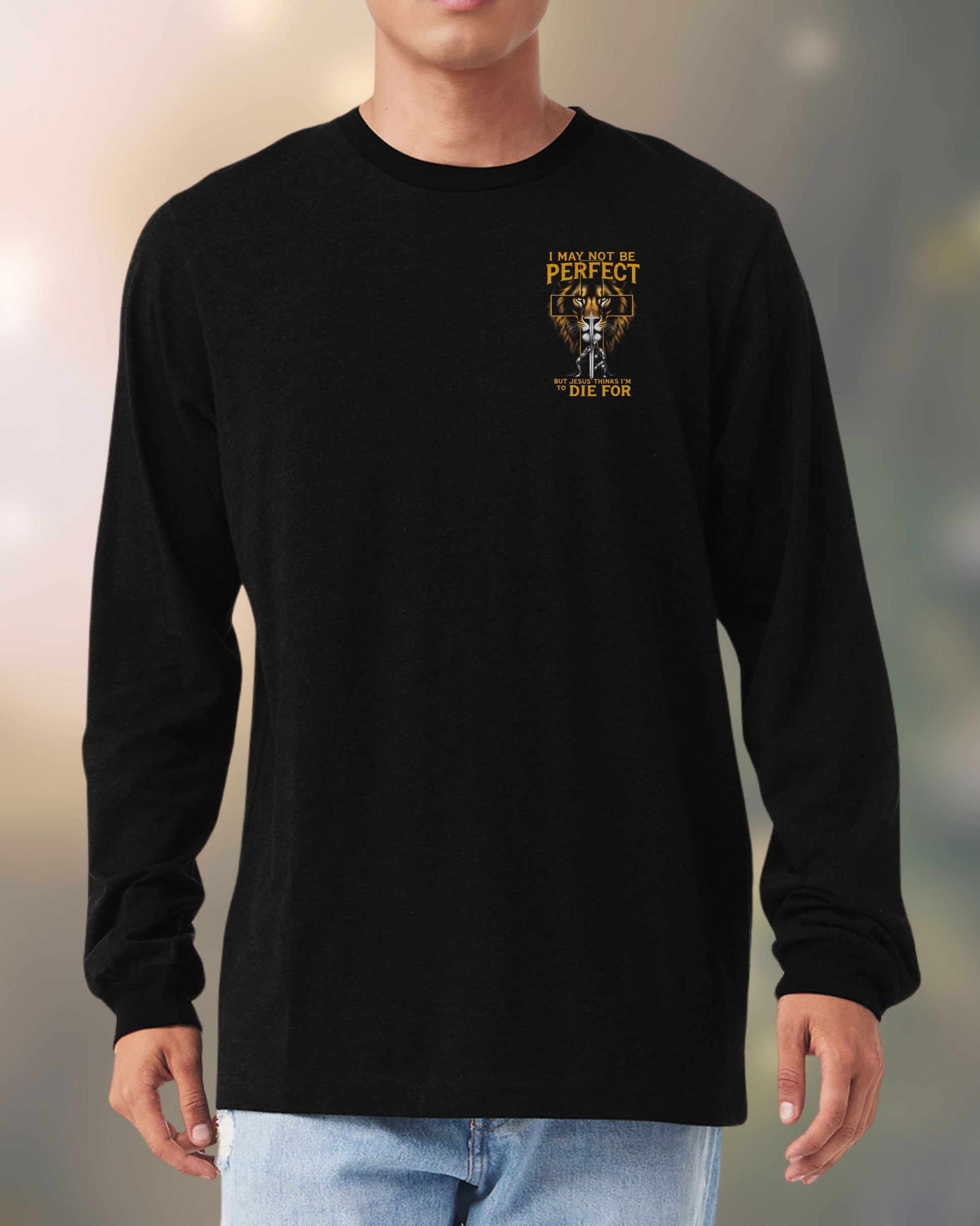 Man wearing black long-sleeve Christian tee with lion and cross design and bold faith message on the front