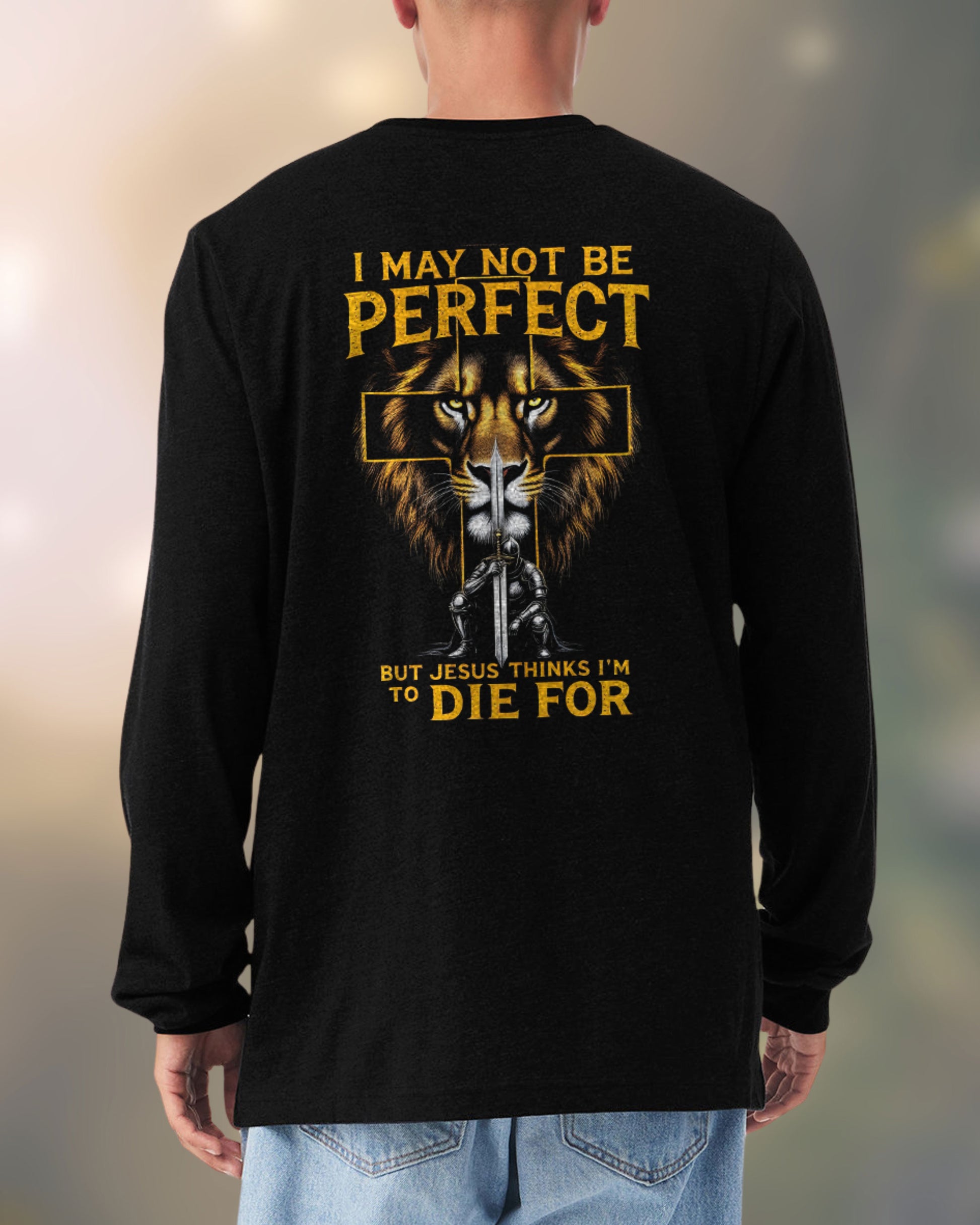 Man wearing black long-sleeve Christian tee with lion and cross design and bold faith message on the back.