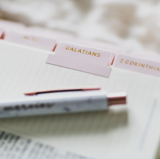 Close-up of a pink blush Bible tab labeled “Galatians” with gold lettering.