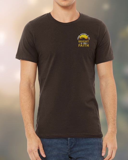 Man wearing a Christian t-shirt with a sunrise and cross design that reads “Your Future Is As Bright As Your Faith.” Front view