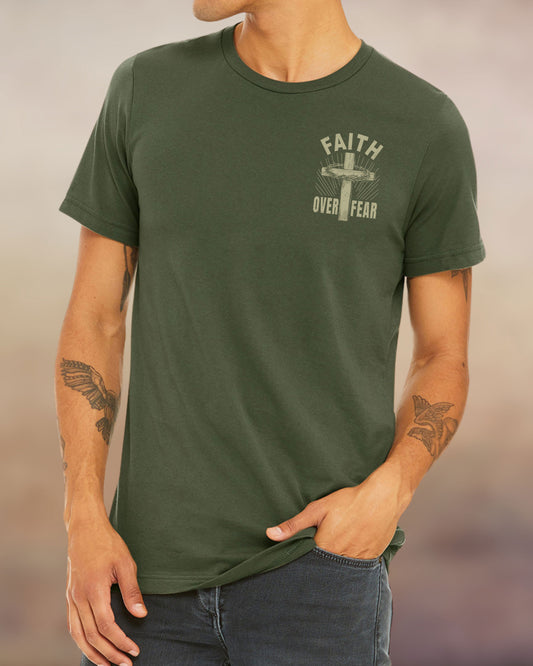 Front view of a military green Christian t-shirt with “Faith Over Fear” design featuring a cross and crown of thorns printed on the back.