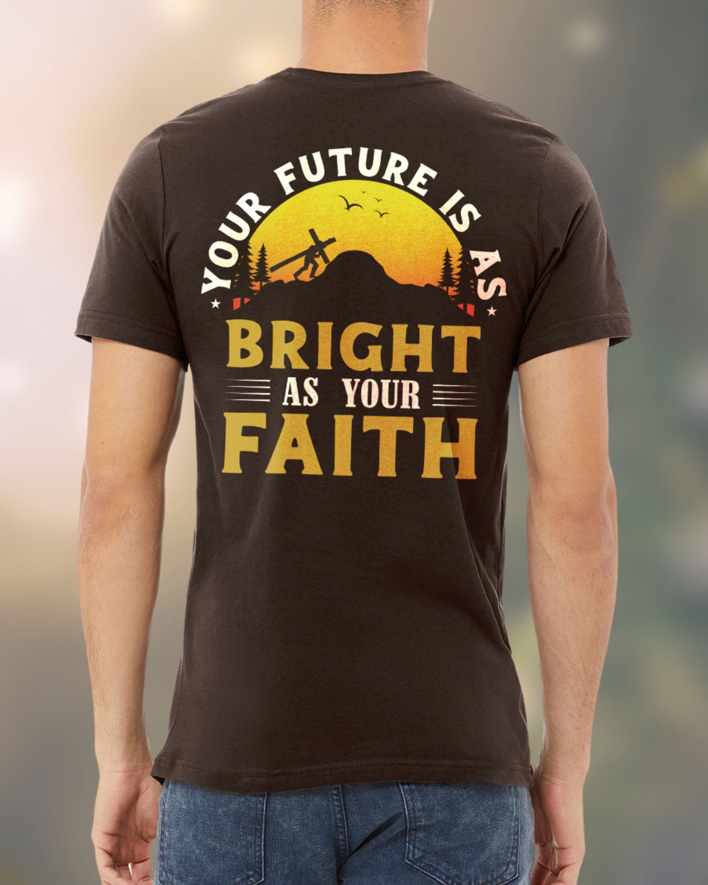 Man wearing a Christian t-shirt with a sunrise and cross design that reads “Your Future Is As Bright As Your Faith.”