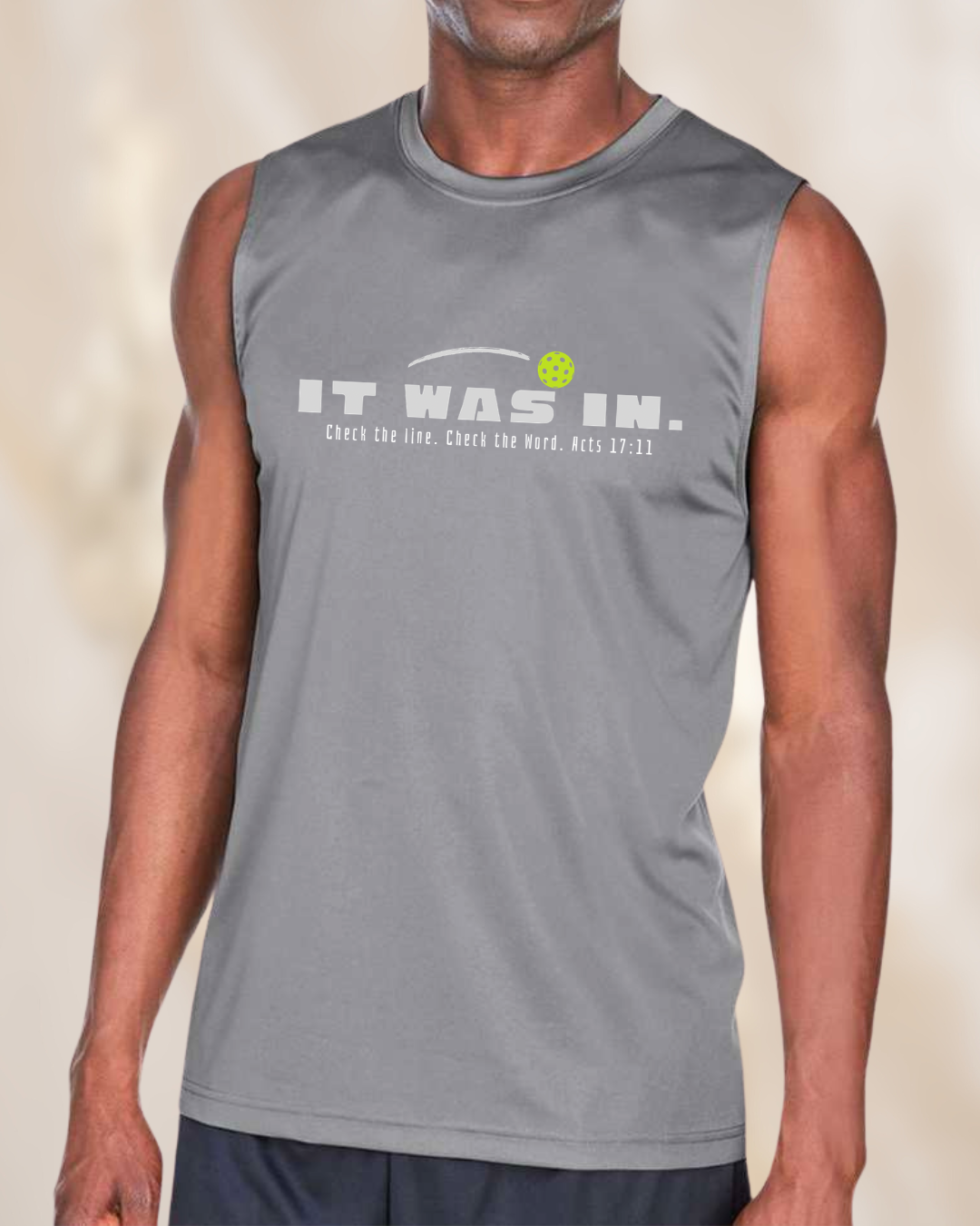 Man wearing a silver sleeveless pickleball performance shirt featuring the phrase “It Was In” and Acts 17:11 reference.