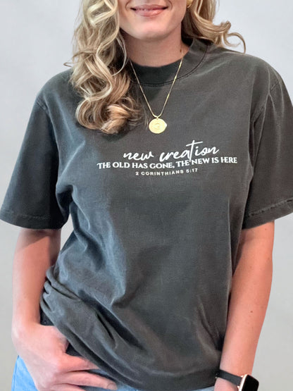 Female model in the New Creation garment-dyed tee highlighting 2 Corinthians 5:17